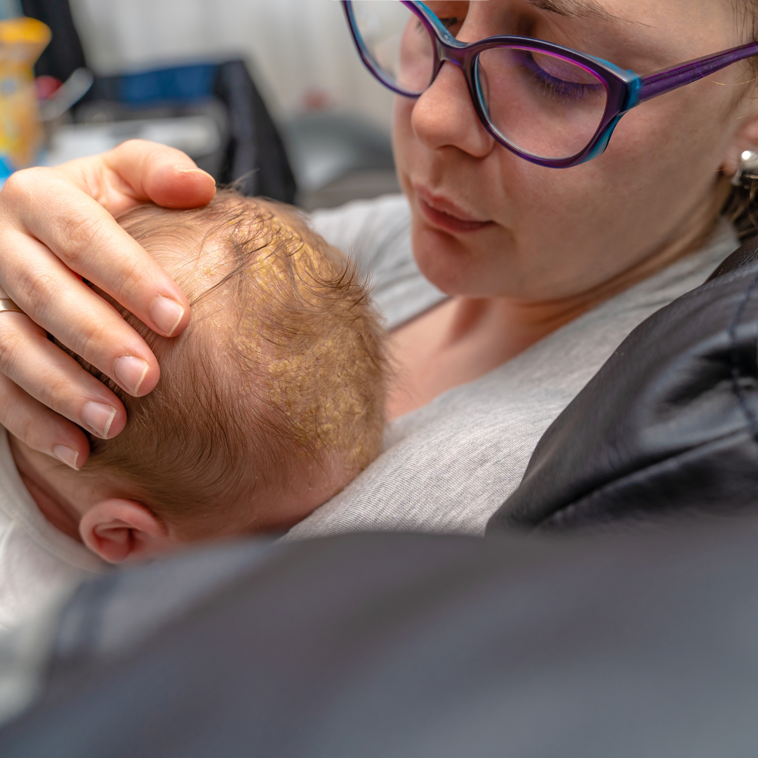 mother cradling baby`s head 