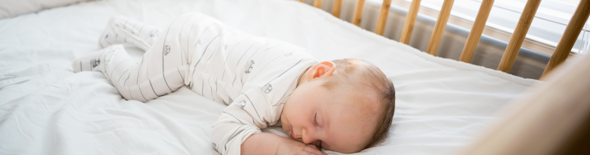 a baby sleeping on a bed